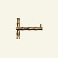 Brass door handle with bamboo design on a beige background