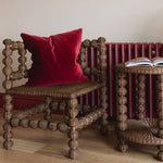 Bobbin-rattan-corner-chair-in-a-corner-with-cusion