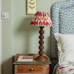 Bobbin-rattan-lamp-base-teak-on-a-side-table