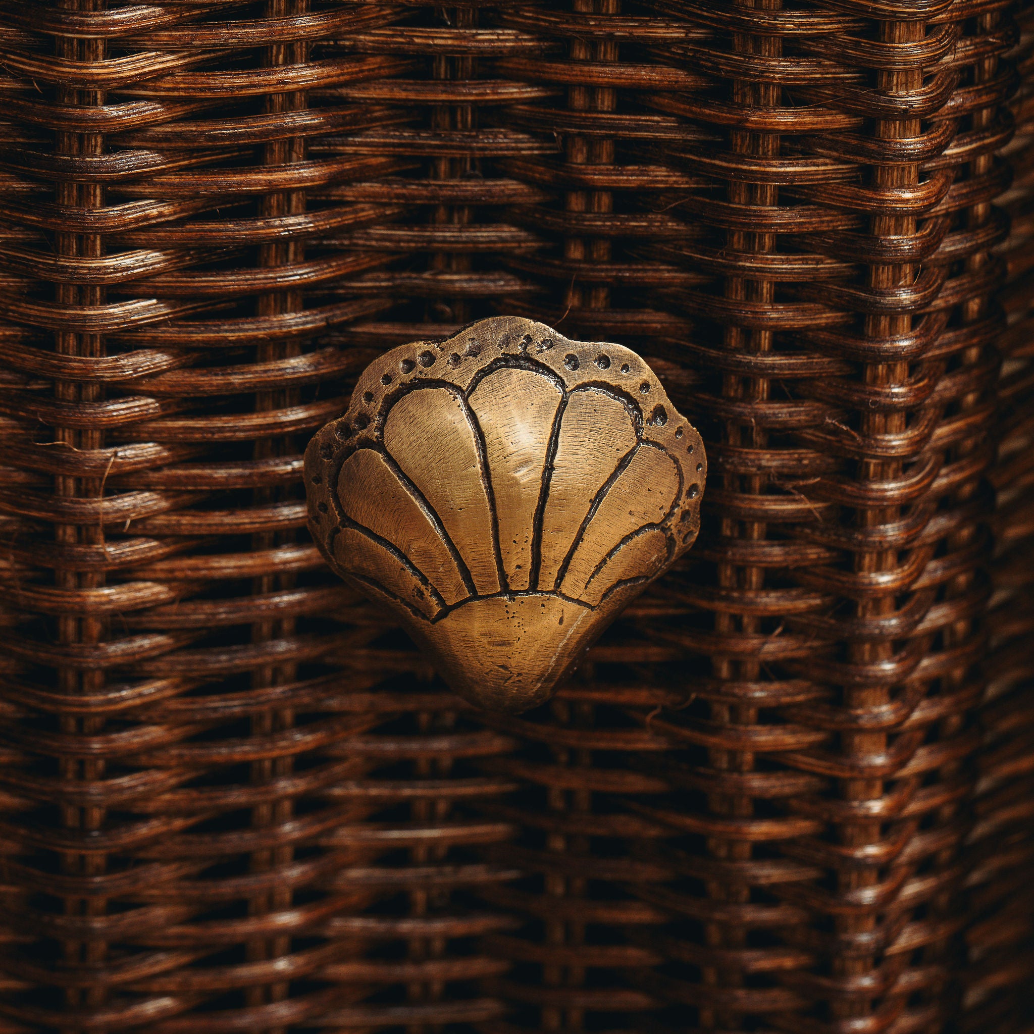 Decorative metal shell on a woven brown background