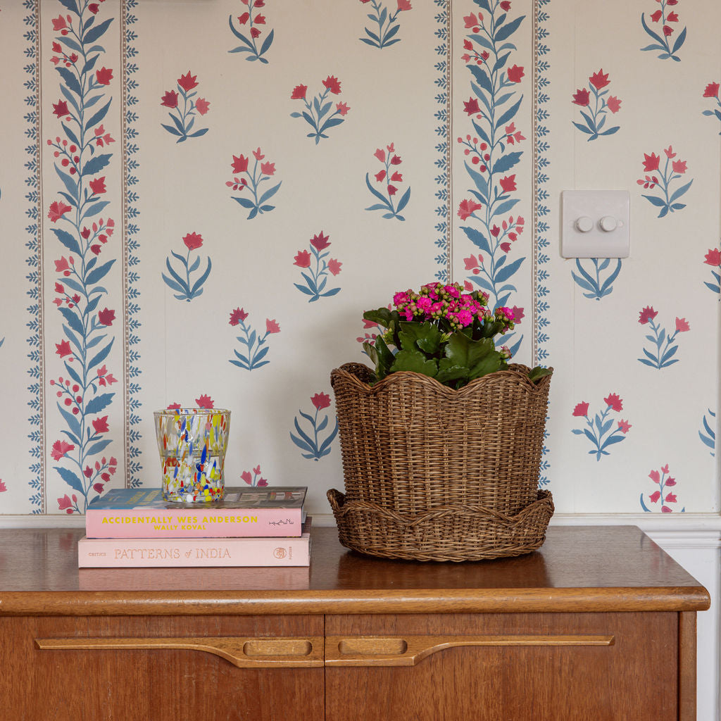 Clara-rattan-bin-planter-small-with-flowers