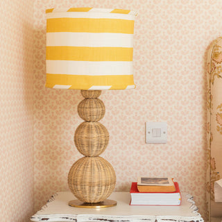 CLARRISE-RATTAN-BRASS-TABLE-LAMP-ON-THE-SIDE-TABLE