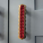 Delilah Handle, Red & Lacquered Brass on cabinet
