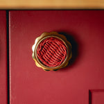 Delilah Round Knob Red, Lacquered Brass red background