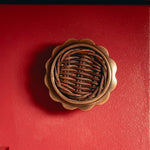 Delilah Round Knob Teak, Aged Brass on red background