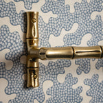 Brass door handle on a textured blue and white background