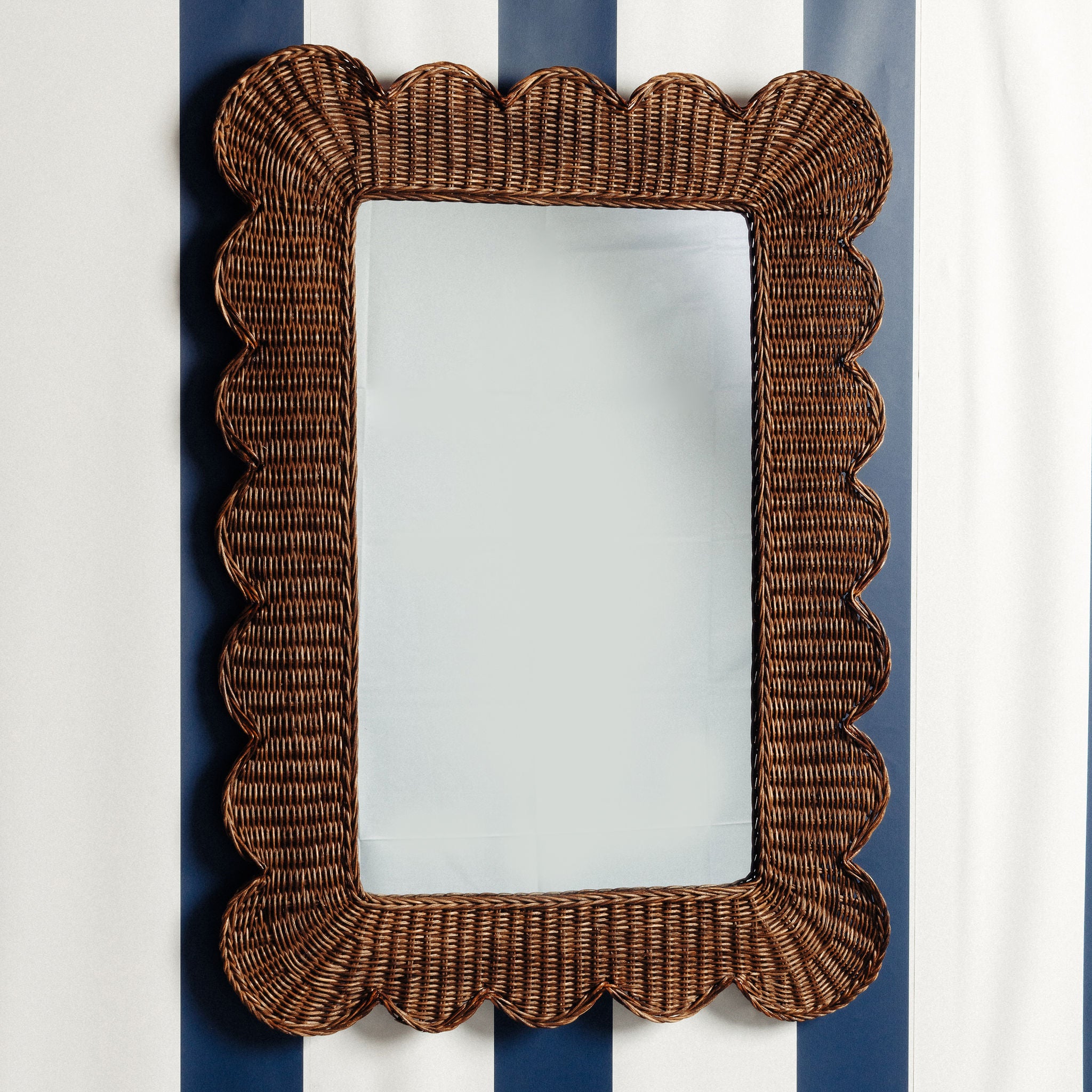 Mimi-scalloped-mirror-large-teak-on-a-wall