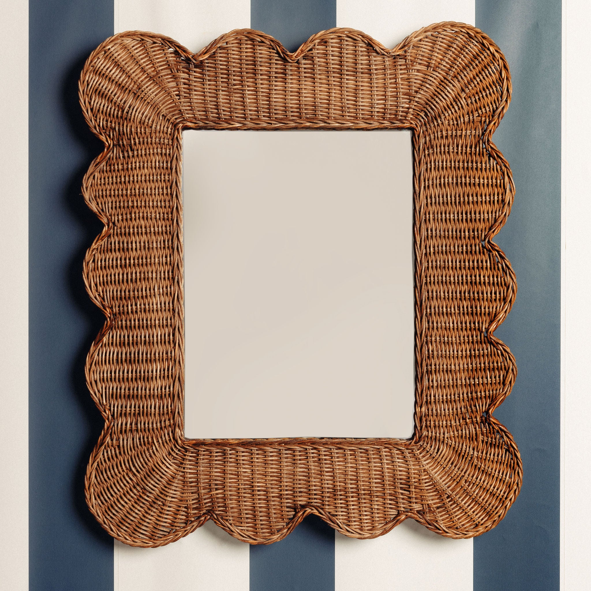 Mimi-scalloped-mirror-medium-teak-on-a-wall