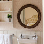 Polly-rattan-round-mirror-in-the-bathroom