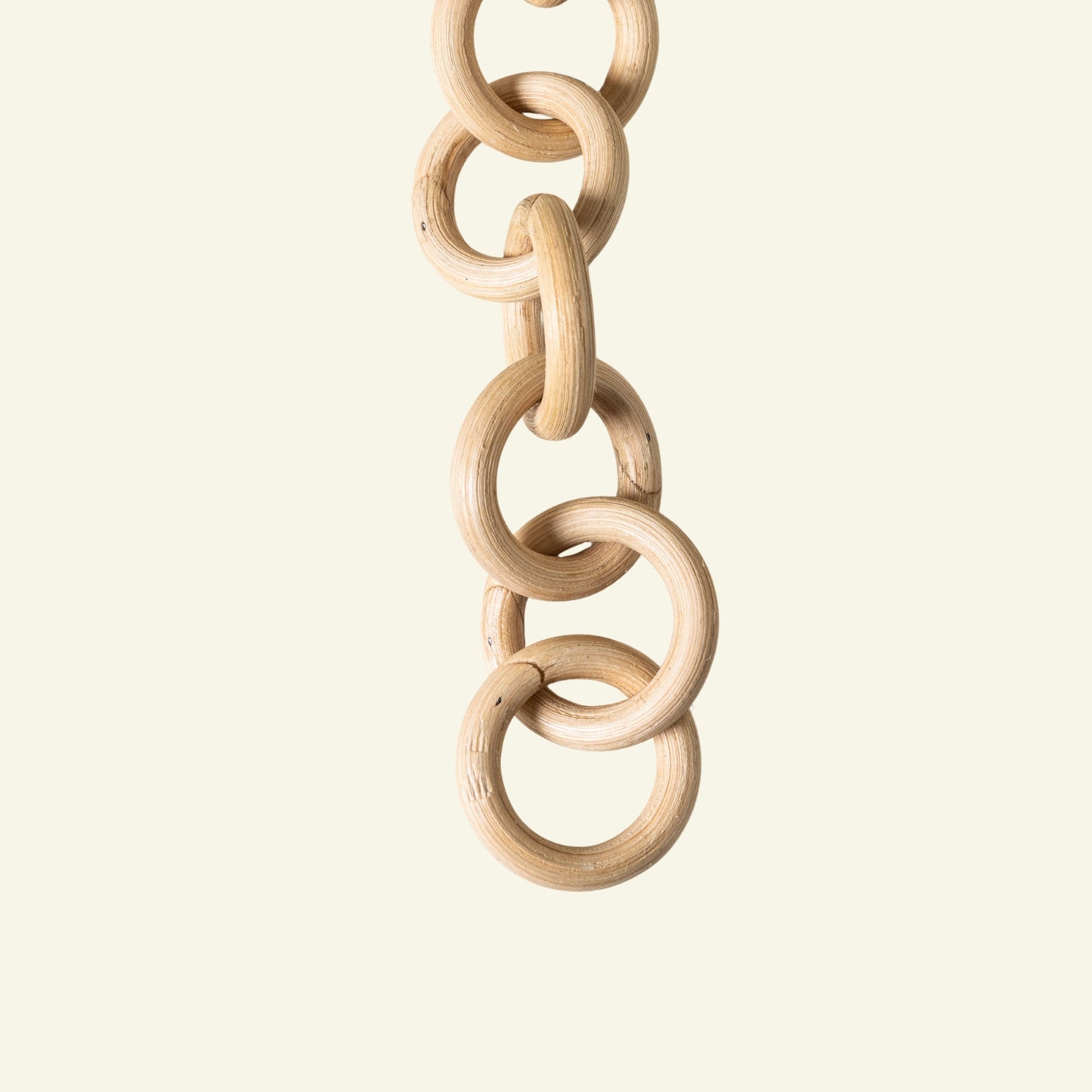 Wooden chain toy on a beige background