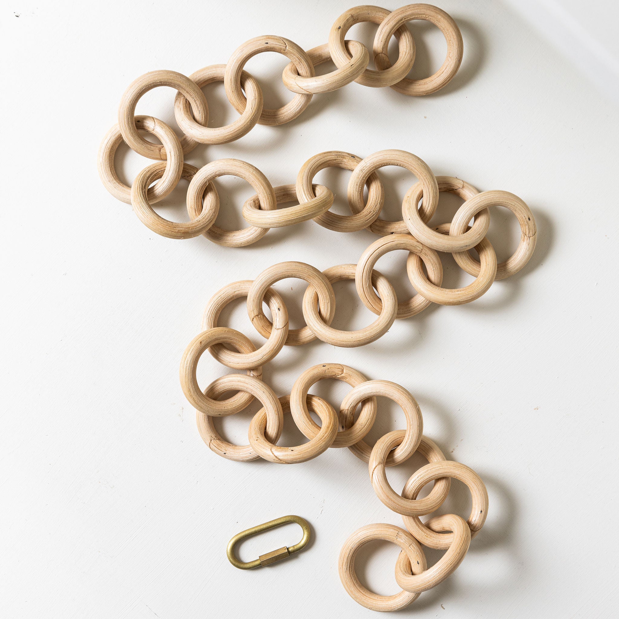Beige chain with a gold clasp on a white background