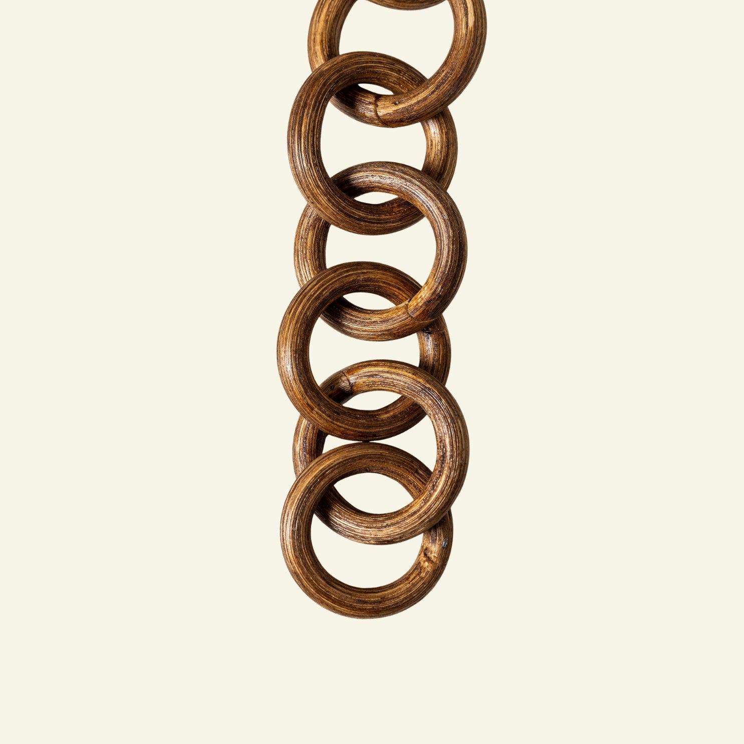 Close-up of a wooden chain on a beige background