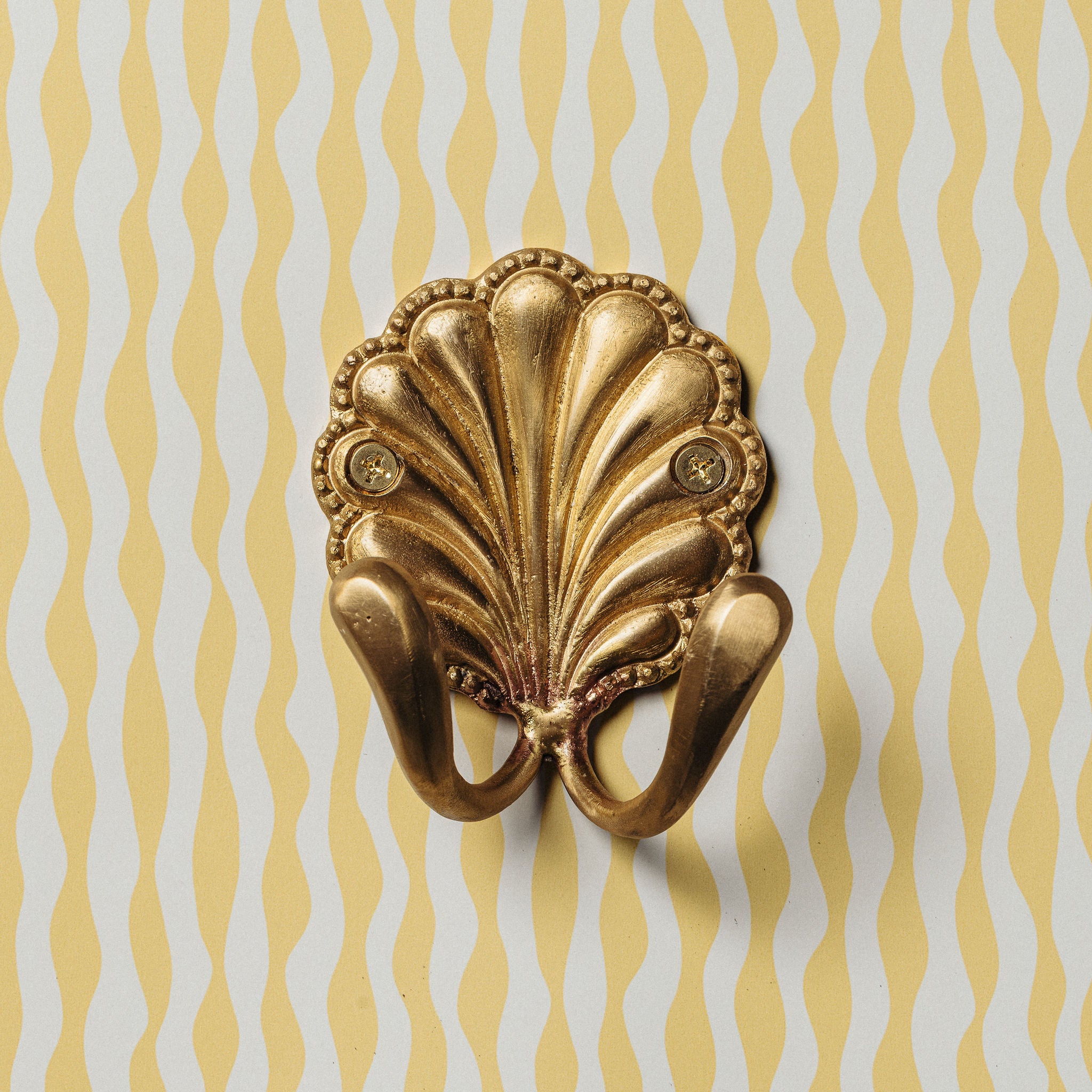 SHELL-BRASS-WALL-HOOK-DOUBLE-ON-A-WALL