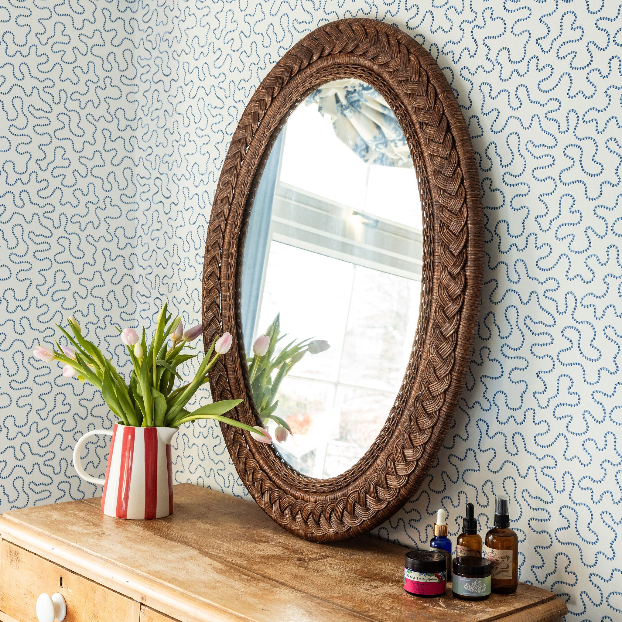 Serena-oval-mirror-teak-large-on-a-chest-of-drawer