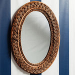 Serena-oval-mirror-teak-on-a-wall