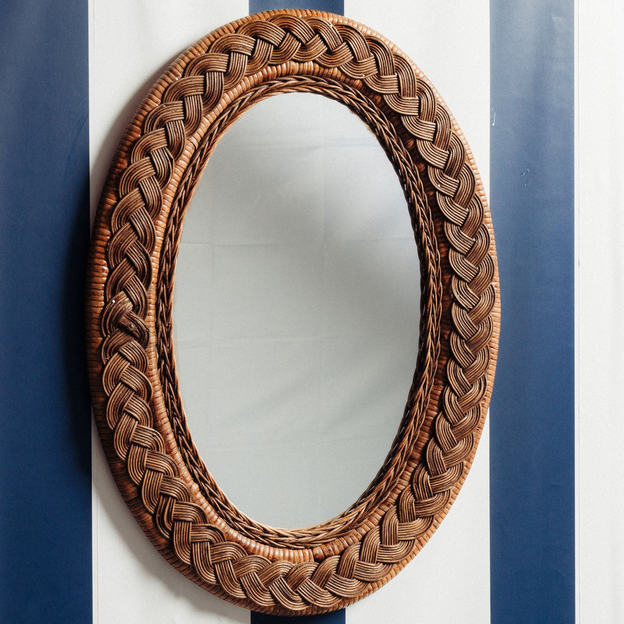 Serena-oval-mirror-teak-on-a-wall