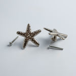 Starfish-shaped dresser knobs on a light gray background