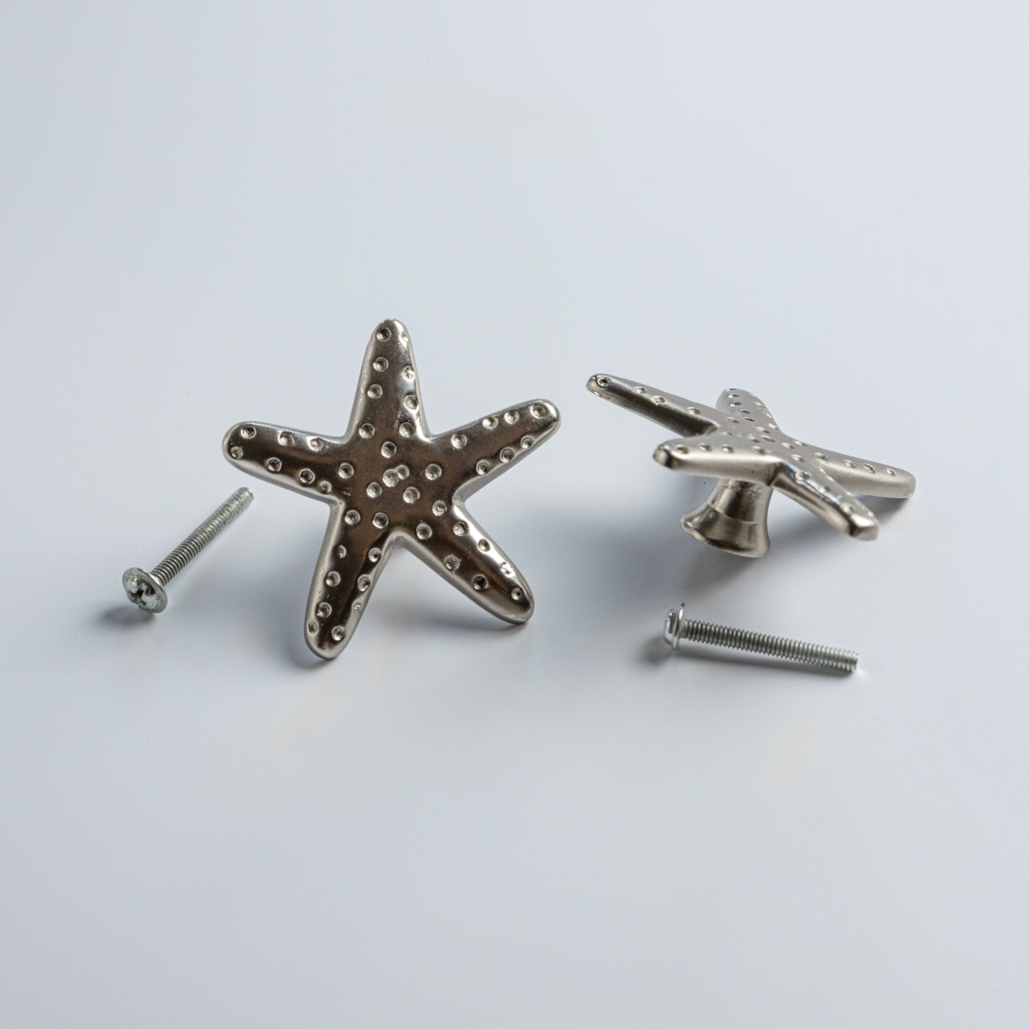 Starfish-shaped dresser knobs on a light gray background