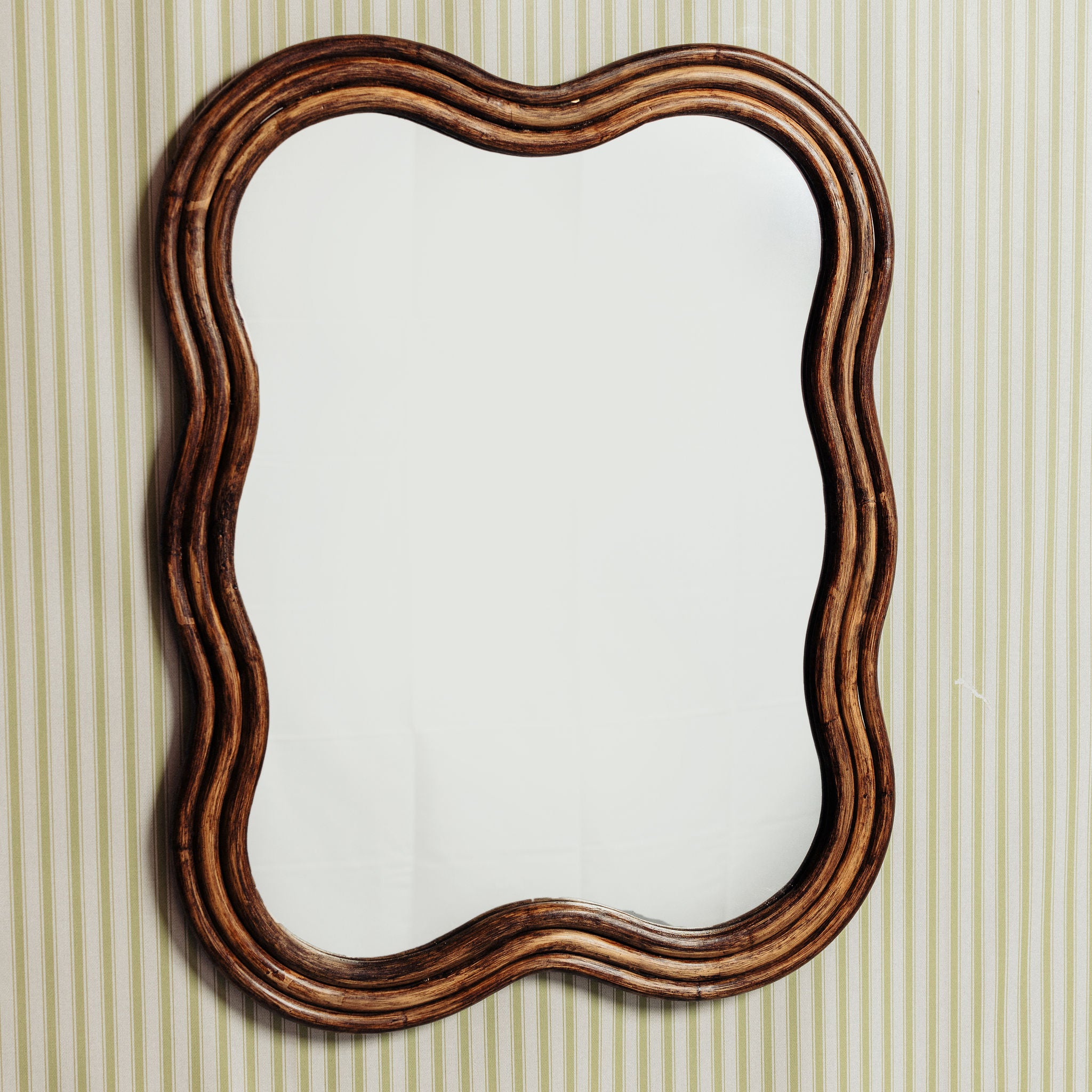 Wave-rattan-mirror-medium-on-a-wall