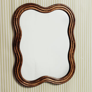 Wave-rattan-mirror-medium-on-a-wall